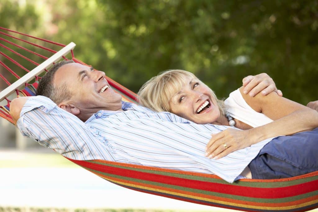 Senior couple outside relaxing in hammock