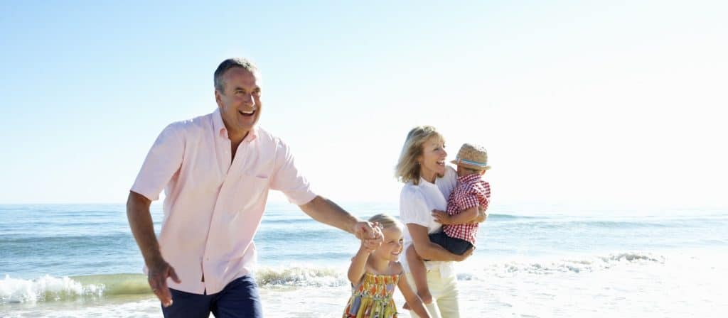 Family laughing and enjoying the beach on a sunny day