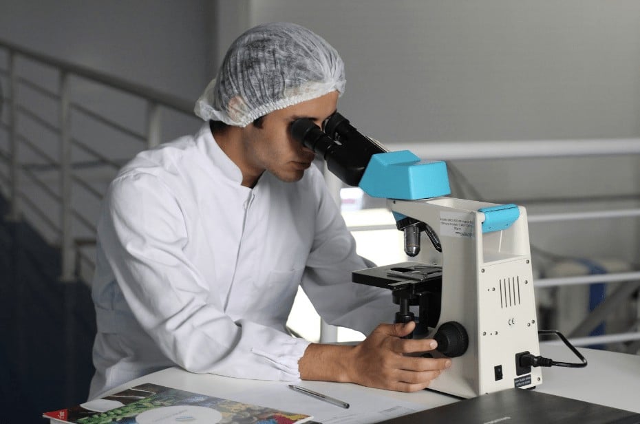 Pharmacist Looking Through Microscope