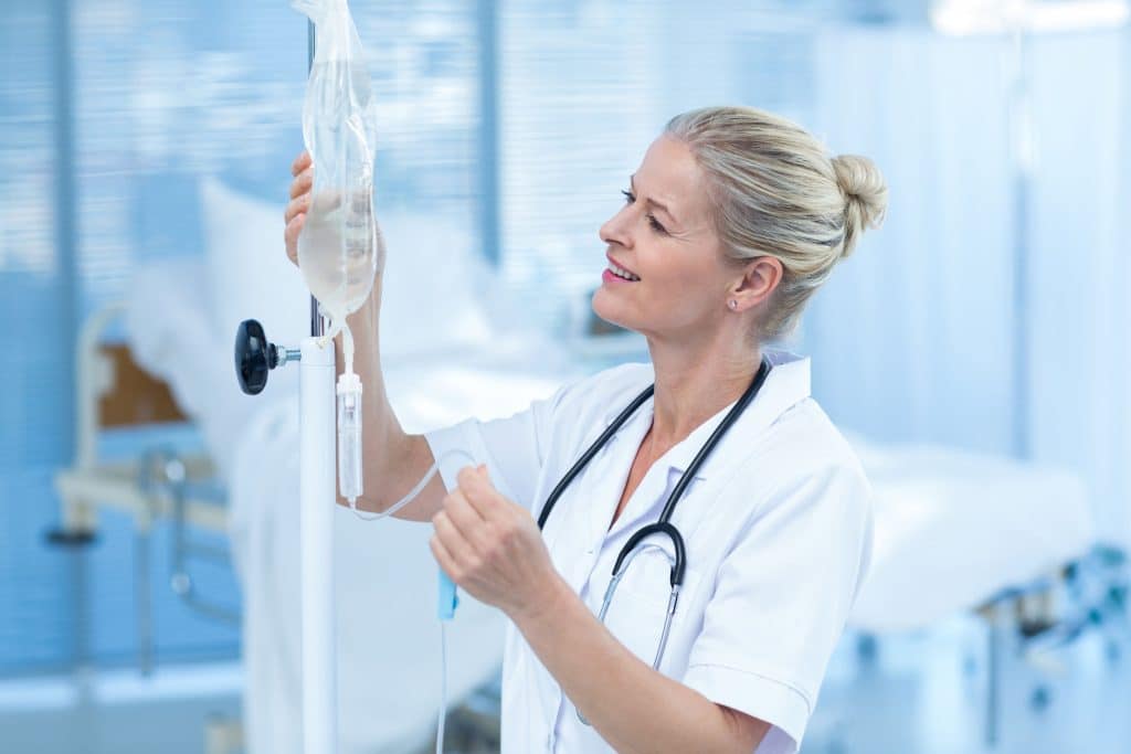 Medical Professional Checking IV Bag — IV Vitamin Therapy Benefits