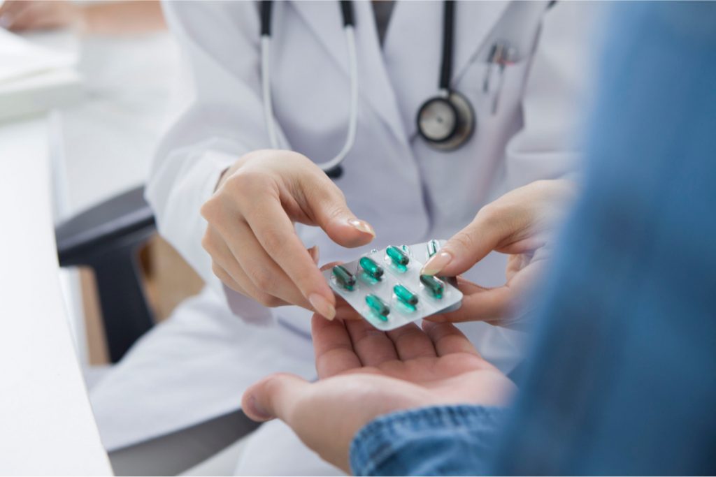 doctor handing a patient medication