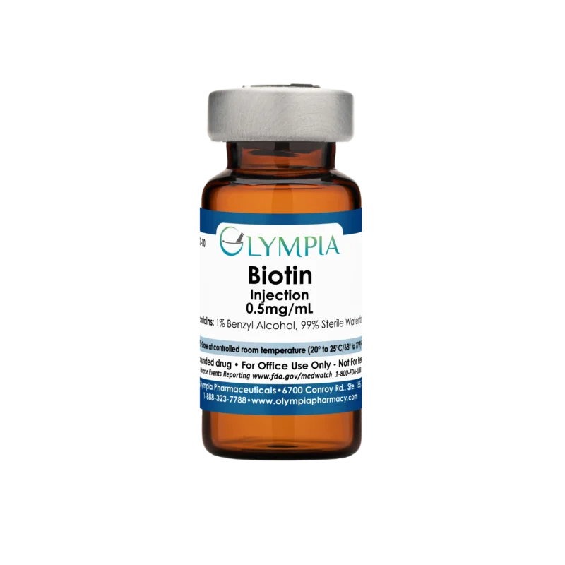 A vial of compounded medication from Olympia. The vial is amber, has a silver cap, and a blue label, reading "Olympia Biotin Injection."