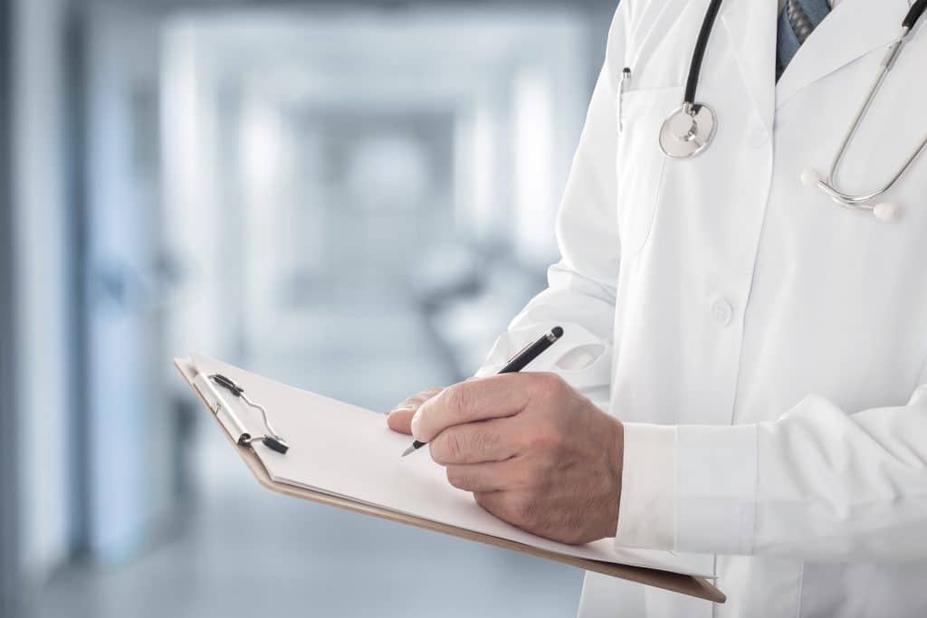 Doctor with clipboard prescribing TriMix injections