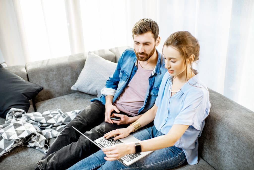 Couple researching ED together on a laptop