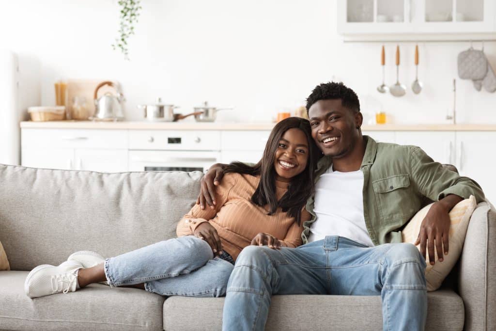 Smiling couple sitting together on the couch