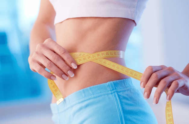 A person with a measuring tape around their waist.