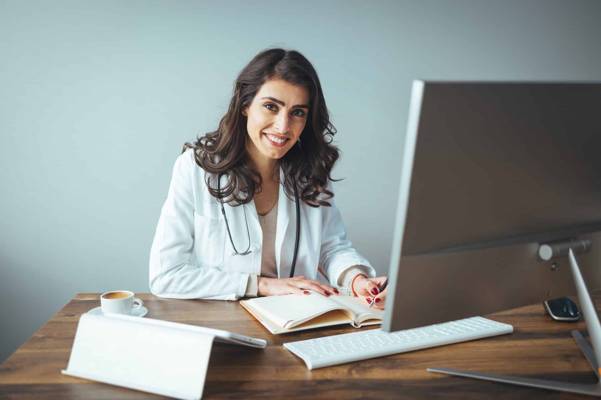 weight loss clinic physician using the computer to learn how to attract more patients