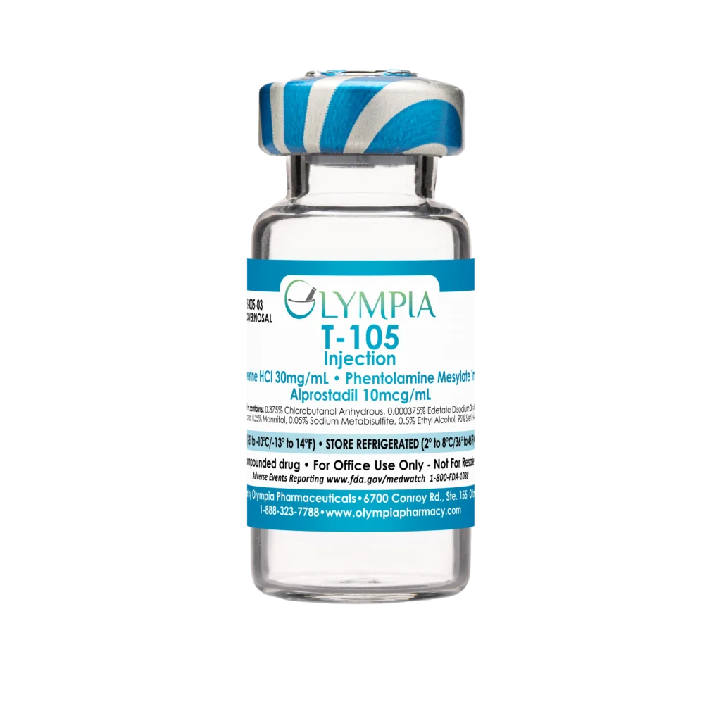 A vial of compounded Trimix ED medication from Olympia. The vial has a blue-white striped cap and a blue label that reads "Olympia T-105 Injection."
