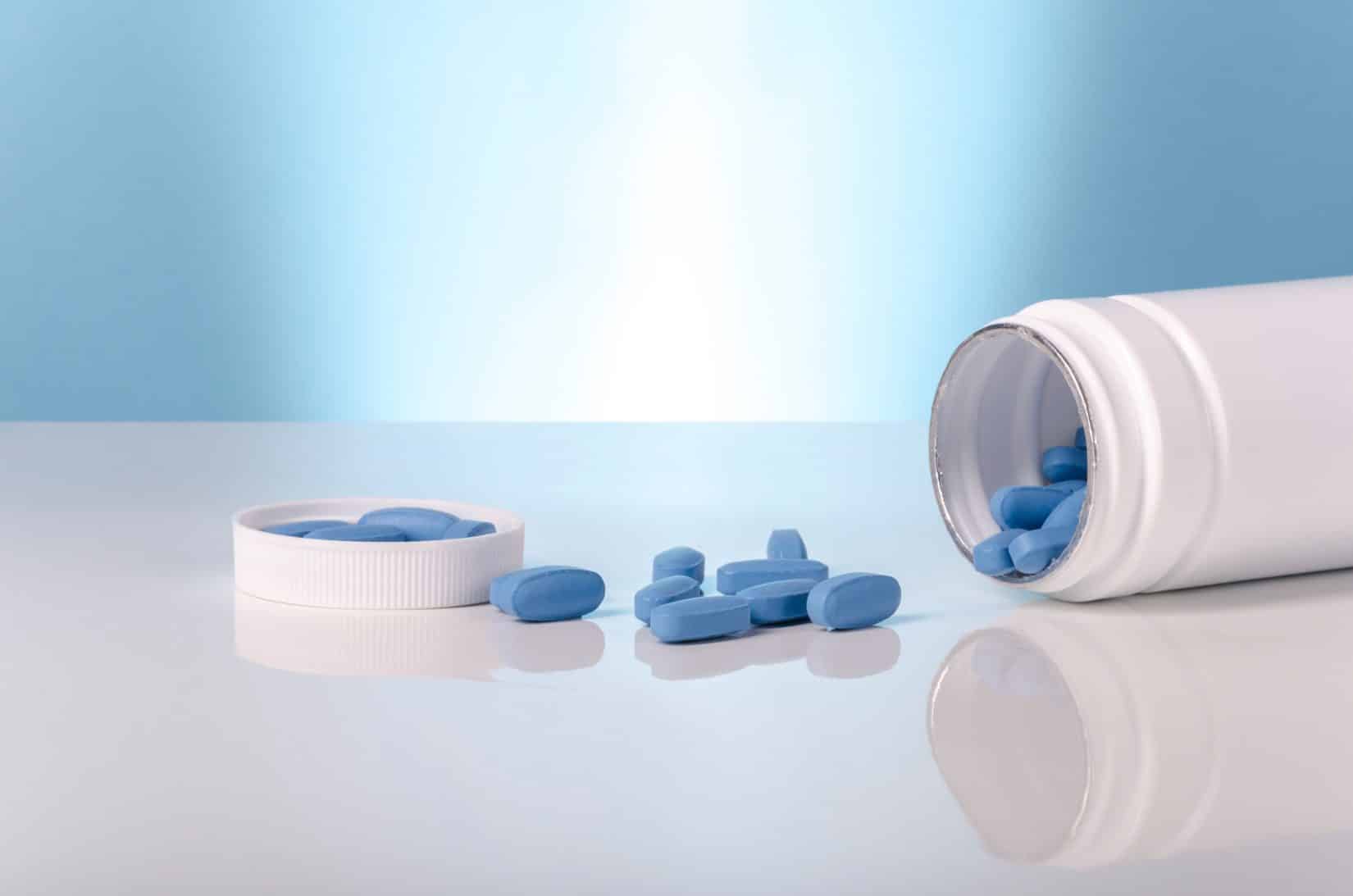 medical viagra blue tablets over white and blue background.