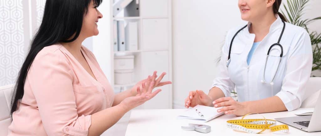 Doctor talking to patient about medical weight loss solutions