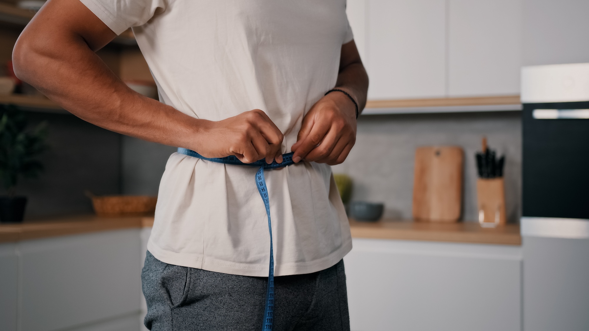 Man measuring his waist