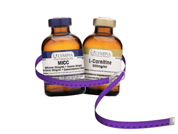 Two amber-colored vials labeled "MICC" and "L-Carnitine 500mg/ml" from Olympia Compounding Pharmacy, wrapped with a coiled purple measuring tape.
