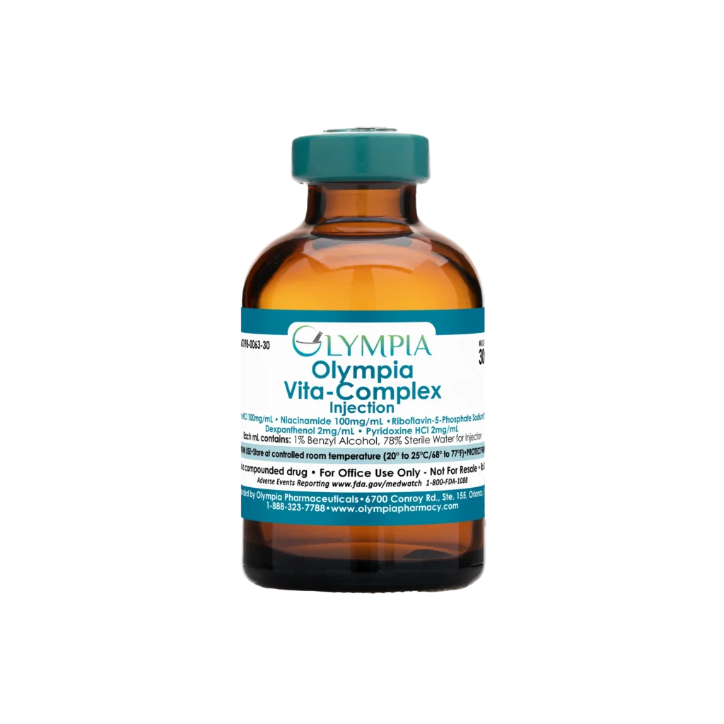 A vial of compounded medication from Olympia. The vial is amber with a teal cap and label, and the label reads "Olympia Vita-Complex Injection."