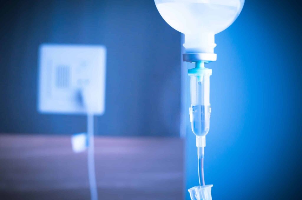 Saline IV drip for patient and Infusion pump in hospital.