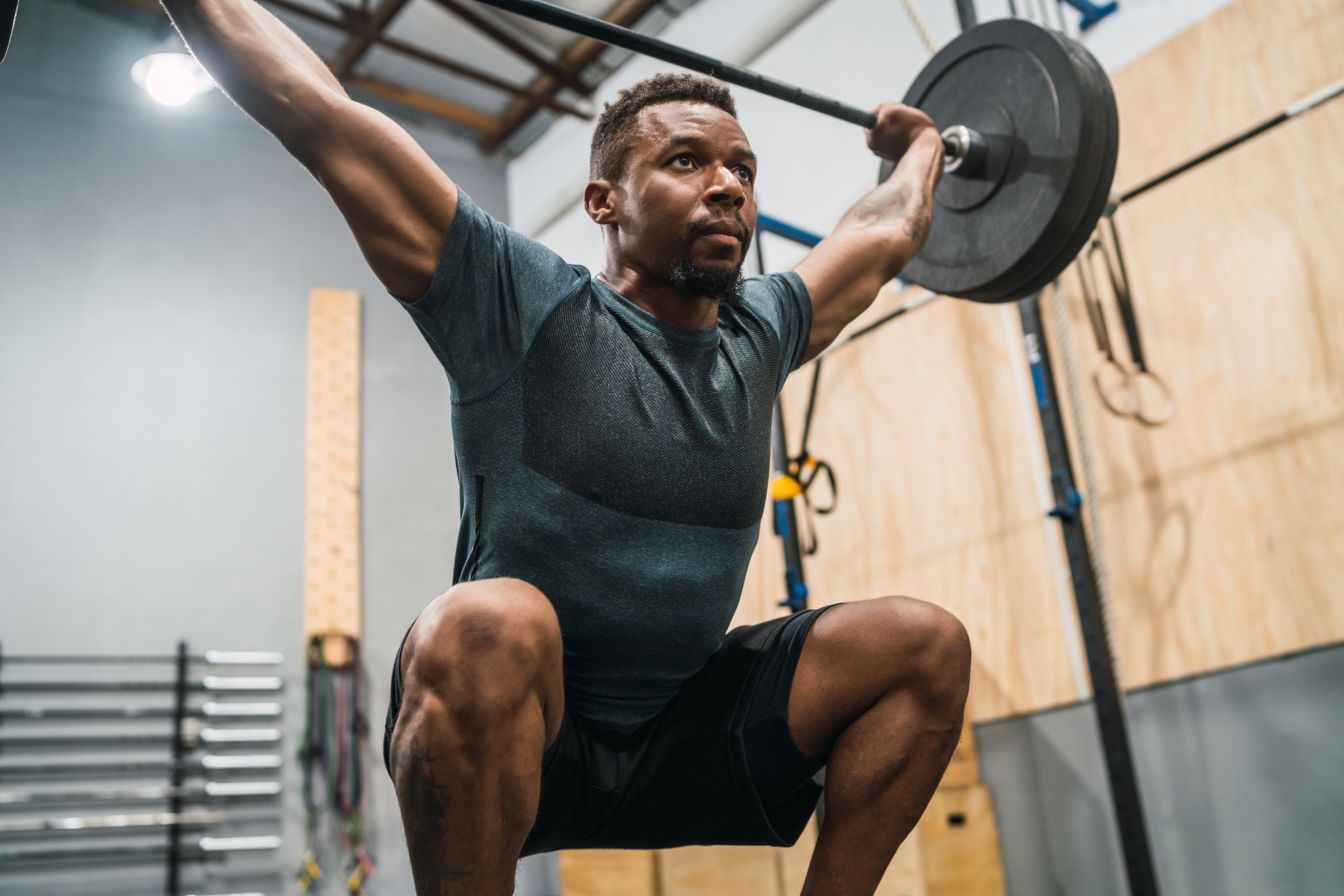 An athlete doing exercise with a barbell.